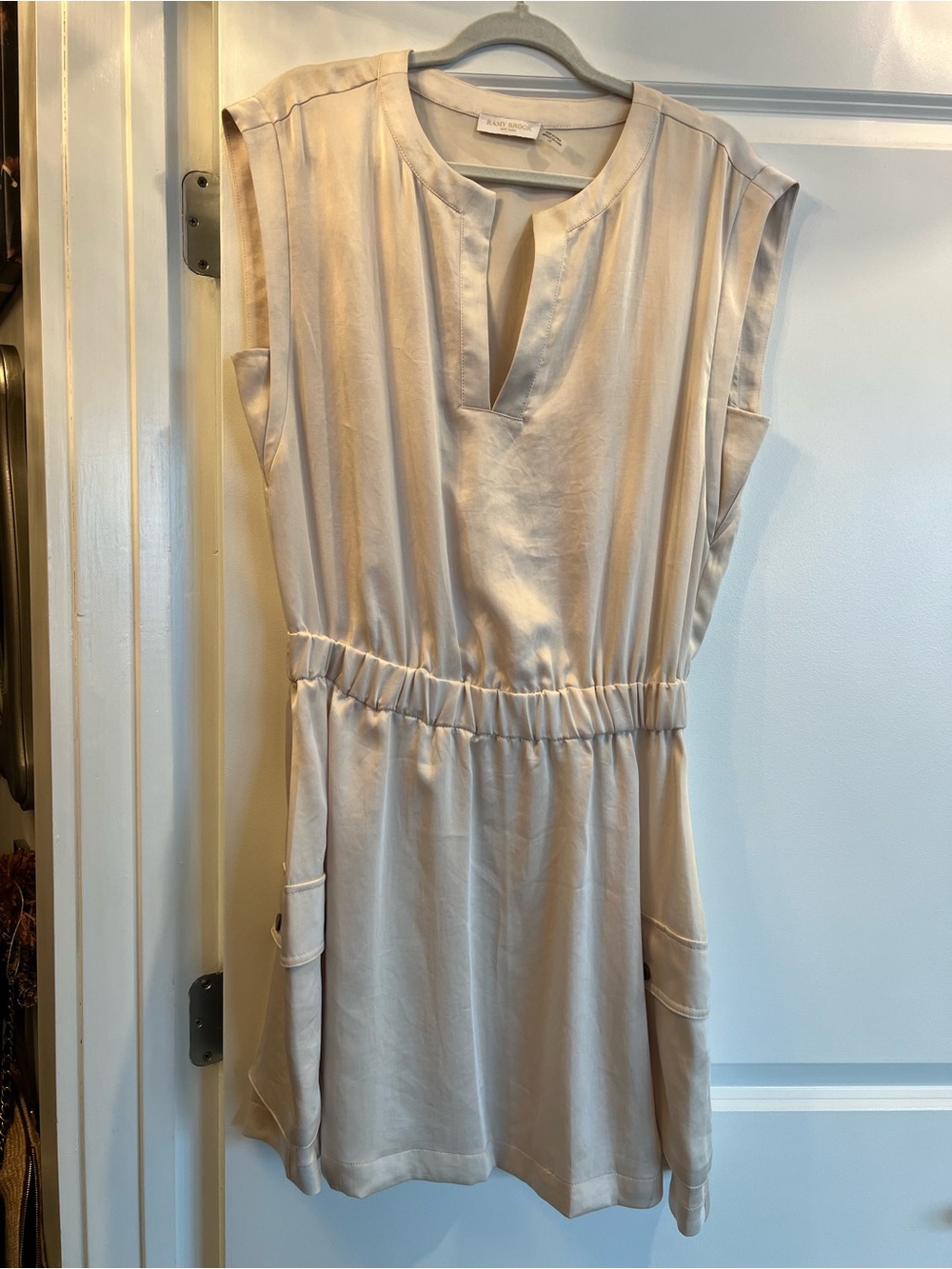 Sleeveless Cream Shirred-Waist Dress with cargo side pockets for a casual look